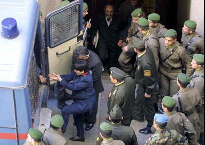 Former Kurdish deputy Leyla Zana, handcuffed gets ready to enter a van after her retrial at a State security court in Ankara, Turkey, Friday, March 28, 2003. Zana is being retried together with three other Kurdish politicians. Zana was originally sentenced to 15 years in prison for collaborating with an outlawed Kurdish group fighting for autonomy in Turkey's southeast. (AP Photo/Nuri Kaynar, Anatolia )