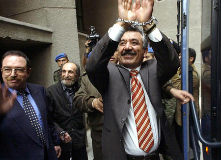 Former Kurdish deputy Leyla Zana, handcuffed gets ready to enter a van after her retrial at a State security court in Ankara, Turkey, Friday, March 28, 2003. Zana is being retried together with three other Kurdish politicians. Zana was originally sentenced to 15 years in prison for collaborating with an outlawed Kurdish group fighting for autonomy in Turkey's southeast. (AP Photo/Nuri Kaynar, Anatolia )